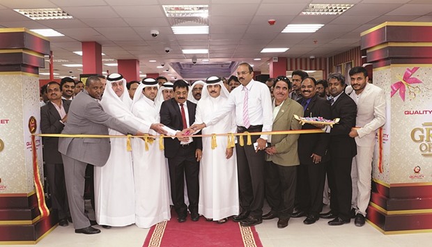 Shamsudheen Olakara and Sheikh Jassim Thamir Issa Thamir al-Thani cutting a ribbon to inaugurate New Quality Hypermarket in the Al Rayyan area yesterday.