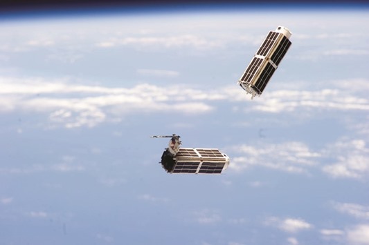 SLICK: A set of NanoRacks CubeSats is photographed by an Expedition 38 crew member after the deployment by the Small Satellite Orbital Deployer (SSOD). The CubeSats programme contains a variety of experiments such as Earth observations and advanced electronics testing.