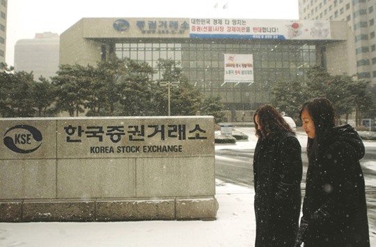 Pedestrians pass by the entrance to the Korean Stock Exchange. If history is any guide, a win for China in getting its yuan shares into MSCI indexes this month would be bad news for South Korea.