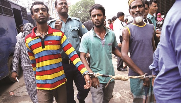 Police escorting arrested men in Dhaka yesterday, who were detained during a anti-militant crackdown across the country.