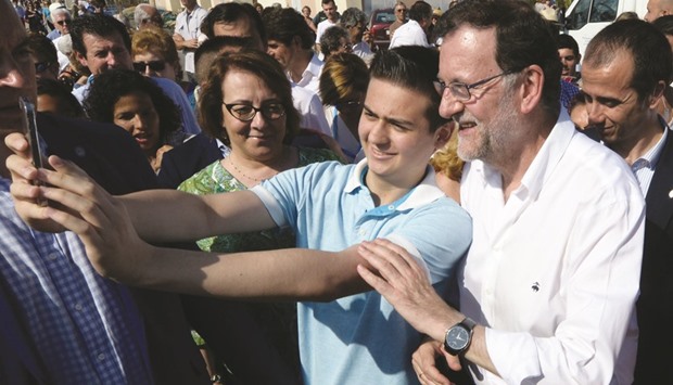 Popularu2019s Party leader and caretaker Prime Minister and party candidate, Mariano Rajoy poses for a u201cselfieu201d during a visit to the fish market in Mediterranean town of Santa Pola.