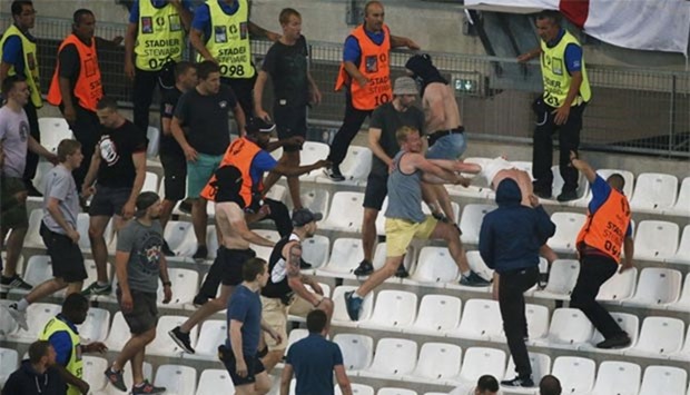Soccer fans clash in the stadium after the match between England and Russia