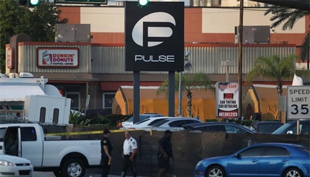 Law enforcement officials investigate near the Pulse Nightclub in Orlando, Florida on Monday.