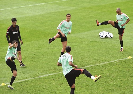 Portugalu2019s forward Cristiano Ronaldo and teammates take part in a training session at the Portugalu2019s base camp in Marcoussis, outskirts of Paris, on Sunday. (AFP)