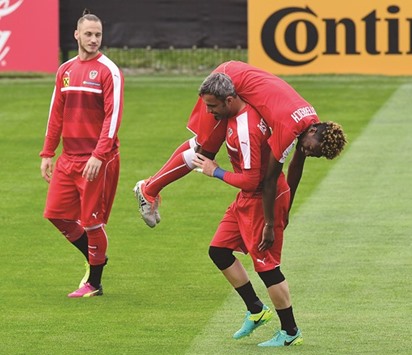 Austriau2019s David Alaba is carried by goalkeeper Ramazan Oezcan during a training session in Mallemort, France, on Saturday. (AFP)