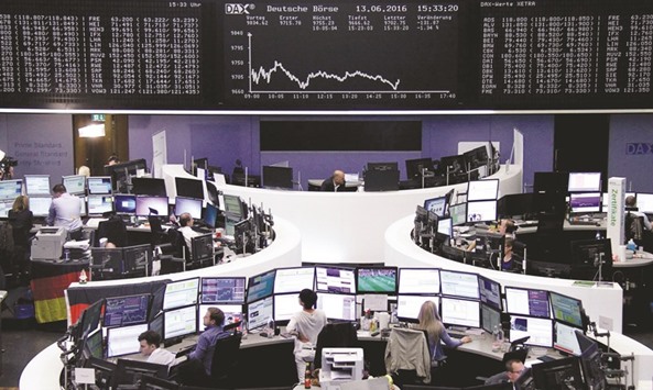 Traders work at the Frankfurt Stock Exchange. The DAX 30 closed down 1.8% to 9,657.44 points yesterday.