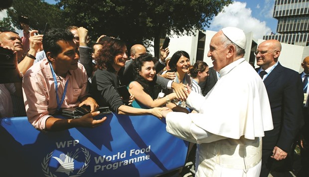 Pope Francis greets workers during a visit at the United Nations World Food Progamme headquarters in Rome yesterday.