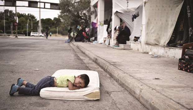 A refugee boy rests in the makeshift camp situated at the old Athens airport.