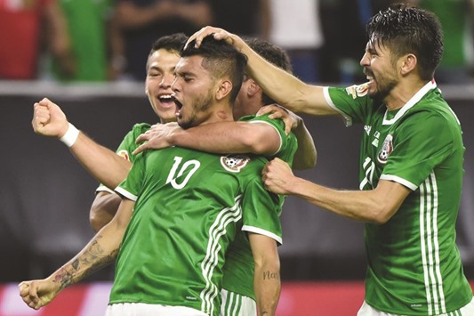 Mexicou2019s Jesus Manuel  Corona (centre) celebrates with teammates after scoring against Venezuela during their Copa America Centenario match in Houston, Texas. (AFP)