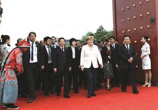 German Chancellor Angela Merkel (centre) arrives at the Imperial Palace in Shenyang, Liaoning province yesterday. Merkel urged China yesterday to take greater responsibility for the global steel market.