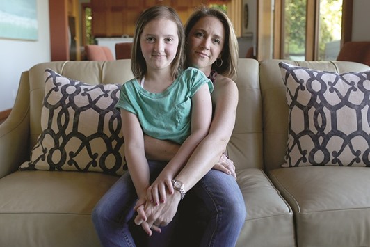 MUMu2019S THE WORD: Jen Belle and her daughter, Katie, 10, pose for a portrait in the living room of their home in Seattle. Katie underwent a clinical trial for neuroblastoma, a form of cancer.