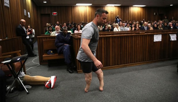 Paralympic gold medalist Oscar Pistorius walks across the courtroom without his prosthetic legs during the third day of the resentencing hearing for the 2013 murder of his girlfriend Reeva Steenkamp, at Pretoria High Court, South Africa.
