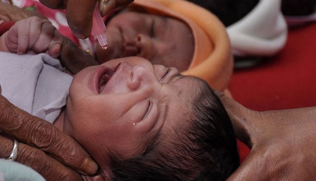 In this photograph taken on February 22, 2015, an Indian health personnel administers the polio vaccine to a newborn baby at a government hospital in Agartala, the capital of the northeastern state of Tripura.  AFP