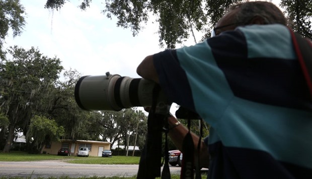 A member of the media waits outside a house that according to local media is owned by Omar Mateen's wife Noor Salam's brother is pictured in Fort Pierce, Florida, US