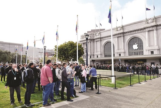 Attendees wait in line outside the Bill Graham Civic Auditorium ahead of the Apple World Wide Developers Conference (WWDC) in San Francisco on Monday. Apple unveiled a crop of new AI-powered features at the conference.