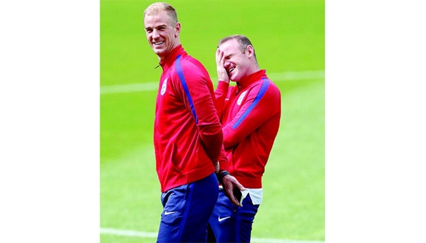 Englandu2019s goalkeeper Joe Hart (left) and captain Wayne Rooney take a break during a training session in Lens, France. (Reuters)