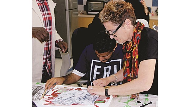 British artist Rachel Gadsden working with a student of Al Noor Institute during the workshop.