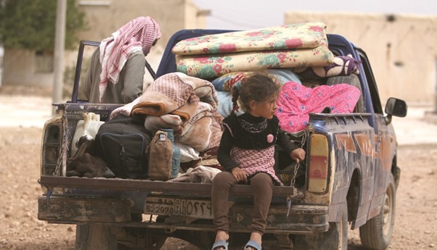 A family that fled a village near Manbij, return to southern rural Manbij where Syria Democratic Forces (SDF) have taken control, in Aleppo Governorate, Syria, yesterday.