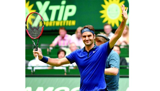 Roger Federer celebrates his win over Malek Jaziri of Tunisia at the ATP tournament match in Halle, western Germany. (AFP)