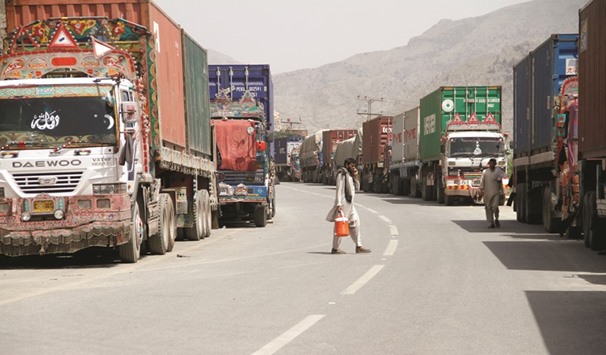 Transit trucks stranded due to the border skirmishes between Pakistan and Afghanistan are parked on the side of the road leading to the border in Torkham, Pakistan yesterday.