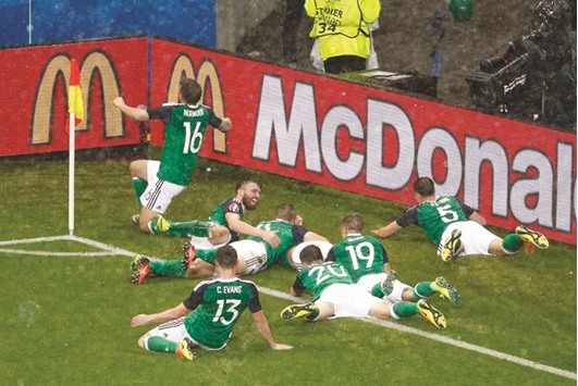 Northern Ireland players celebrate after their 2-0 win over Ukraine yesterday. (Reuters)