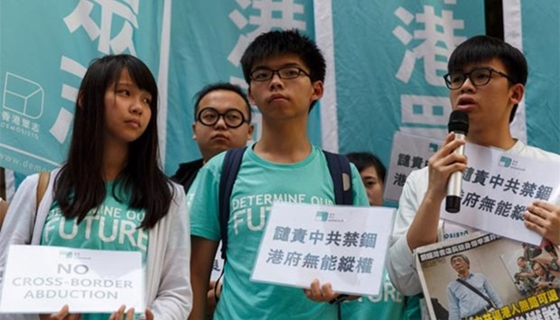 Leading student activist Joshua Wong (centre) joins other pro-democracy group Demosisto members as they protest in Hong Kong on Friday.