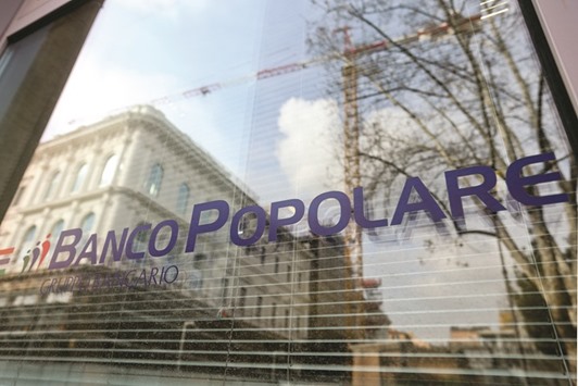 The Banco Popolare logo is seen on a window of the banku2019s branch in Rome. In Milan, Banco Popolare soared nearly 17% higher, pushing the FTSE Mib index to close up 3.5%.