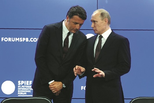 Russian President Vladimir Putin talks to Italyu2019s Prime Minister Matteo Renzi as they attend a signing ceremony following their talks at the St. Petersburg International Economic Forum (SPIEF 2016) in Saint Petersburg yesterday.