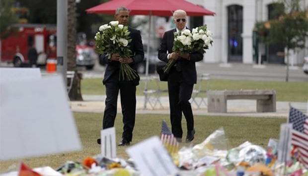 President Barack Obama and Vice President Joe Biden place flowers at a makeshift memorial for shooting victims of the massacre at a gay nightclub in Orlando, Florida, on Thursday.