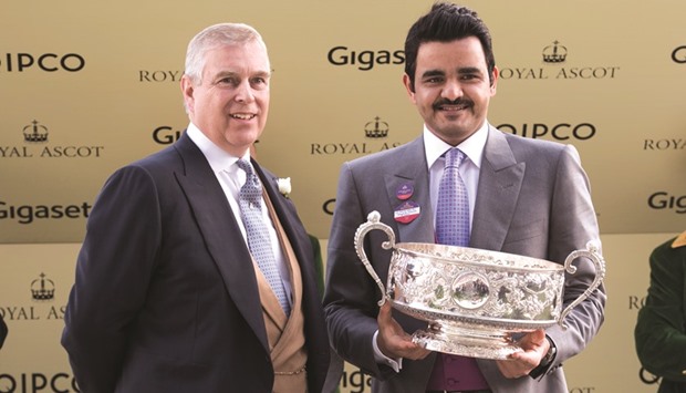 HE Sheikh Joaan bin Hamad al-Thani receives the trophy from Prince Andrew, Duke of York, after Al Shaqab Racingu2019s Qemah won the Coronation Stakes at Ascot yesterday.
