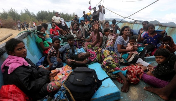 Sri Lankan immigrants on their boat after being stranded at Pulo Kapuk beach in Lhoknga