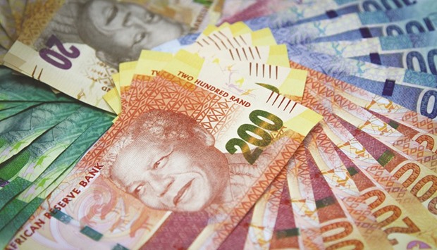 Mixed denomination rand currency banknotes are arranged for a photograph at a First National Bank branch in Johannesburg. The rand is among emerging market currencies most vulnerable to upheaval if Britain votes to leave the European Union, while rouble investors may find some benefit from the isolation provided by sanctions on Russia.