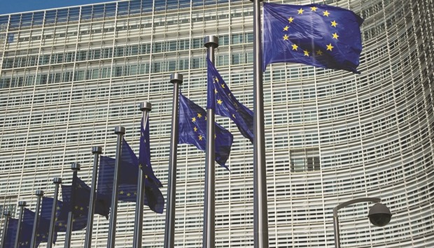 EU flags fly outside the European Commission headquarters building in Brussels. The EU moved closer to imposing tighter restrictions on money market funds after years of wrangling, but stopped short of restrictions the industry said would upend the u20ac1tn market.