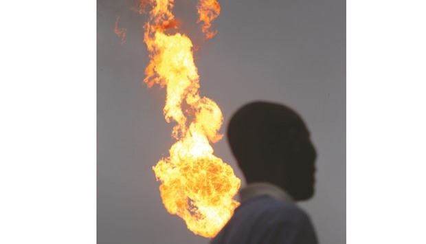 Flames from a gas flare burn at an oil flow station operated by Nigerian Agip Oil Co, a division of Eni, in Idu, Rivers State, Nigeria (file). The countryu2019s oil production has slumped to a 28-year low of 1.37mn bpd, about 480,000 below its full capacity, IEA data show. A militant group calling itself the Niger Delta Avengers has been targeting pipelines and other infrastructure in the African nation for several months.