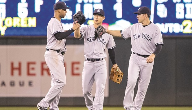 New York Yankees left fielder Aaron Hicks (31) along with right fielder Rob Refsnyder (38) and centre fielder Jacoby Ellsbury (22) celebrate after defeating the Minnesota Twins at Target Field on Friday. Picture: Jesse Johnson-USA TODAY Sports