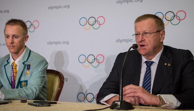 Australian athlete Jared Tallent listens as International Olympic Committee vice-president John Coat