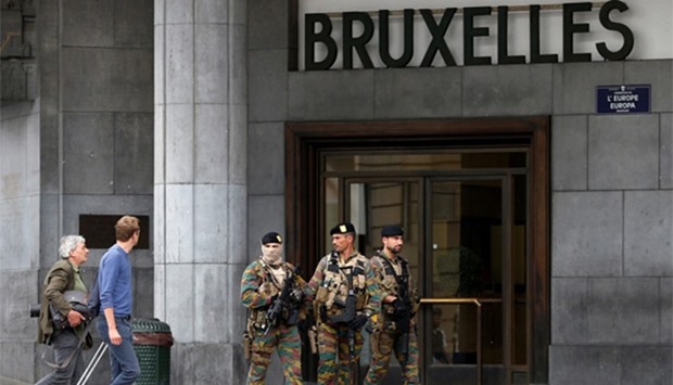 Belgian soldiers patrol outside the central train station in Brussels