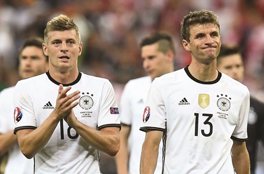 Germanyu2019s midfielder Toni Kroos (L) and midfielder Thomas Mueller acknowledge the crowd following their 0-0 draw in the group C match against Poland.