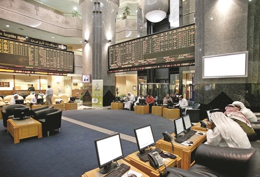 Traders work on the floor at the Abu Dhabi Securities Exchange (file). Abu Dhabiu2019s main stock index added 4.7% yesterday in its heaviest trading day since November 2014.