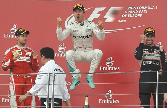 Mercedes Formula One driver Nico Rosberg (C) of Germany celebrates winning the race next to second placed Ferrari Formula One driver Sebastian Vettel (L) of Germany, third placed Force India Formula One driver Sergio Perez of Mexico. (Reuters)