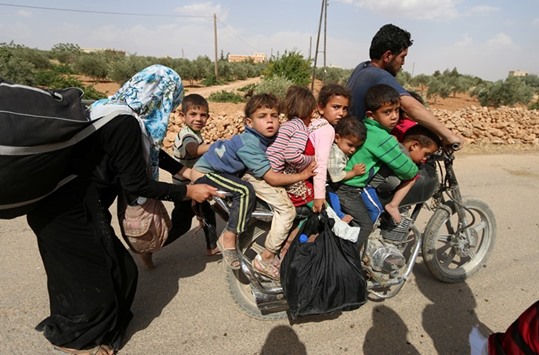 Civilians, who fled the violence in Manbij city, arrive to the southeastern rural area of Manbij, in Aleppo Governorate, Syria yesterday.