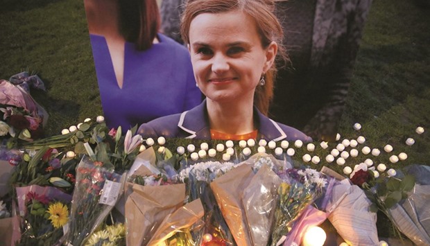 Tributes for Labour Party MP Jo Cox, who was shot dead in the street in northern England, are displayed on Parliament Square in London.