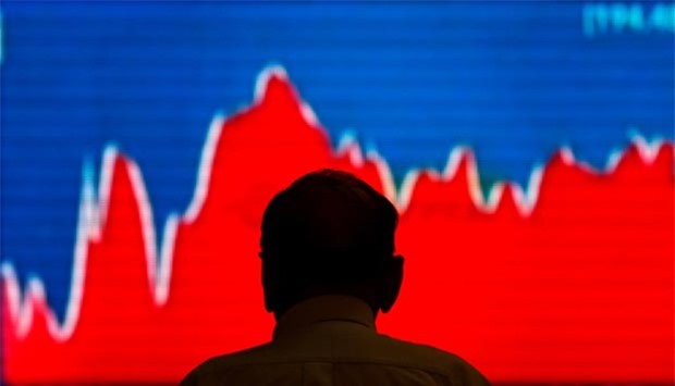 A man looks at a screen displaying news of markets update inside the Bombay Stock Exchange building in Mumbai on Monday.