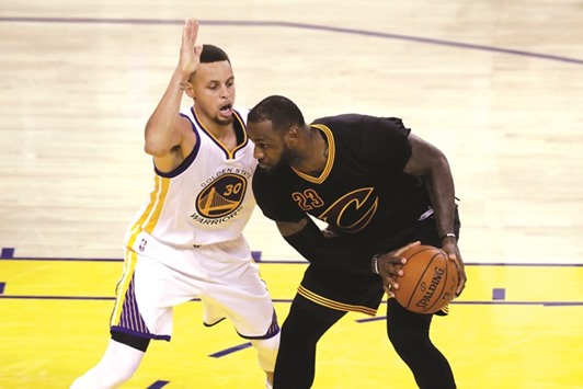 LeBron James tries to get past Stephen Curry of the Golden State Warriors.
