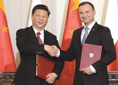Chinau2019s President Xi Jinping (left) and his Polish counterpart Andrzej Duda shake hands after signing a cooperation treaty between the two countries in the presidential palace in Warsaw yesterday.