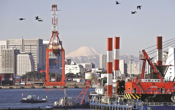 Birds fly in front of Mt Fuji and a crane at a port in Tokyo. Japan logged a trade deficit of u00a540.72bn ($389mn) in May, compared with a trade surplus of u00a5823.18bn in April, as exports of steel and semiconductors declined, the ministry said yesterday.