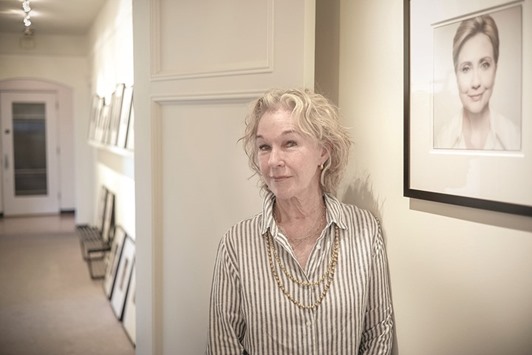DEDICATED: Susie Tompkins Buell poses with a photograph of Hillary Clinton at her penthouse apartment in San Francisco. She has known Bill and Hillary Clinton for 25 years and has raised millions of dollars for them for various campaigns.