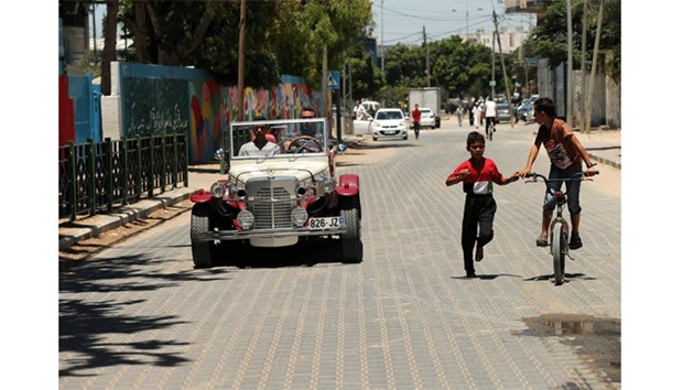 Palestinian Munir Shindi, 36, drives a replica of a 1927 Mercedes Gazelle that he built from scratch, on a street in Gaza City on Sunday.