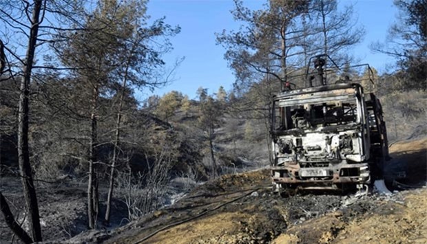 A firetruck from the Cypriot department of forest is seen burnt in the Cypriot village of Evrychou in the Troodos mountain area during a forest fire.