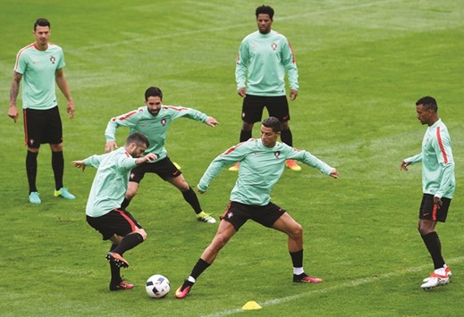 Portugalu2019s captain Cristiano Ronaldo (right) take part in a training session with his teammates in Marcoussis, south of Paris yesterday. (AFP)